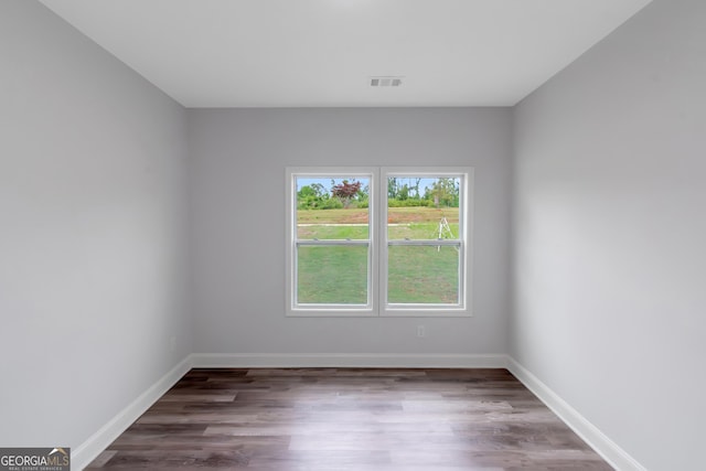 empty room with wood finished floors and baseboards