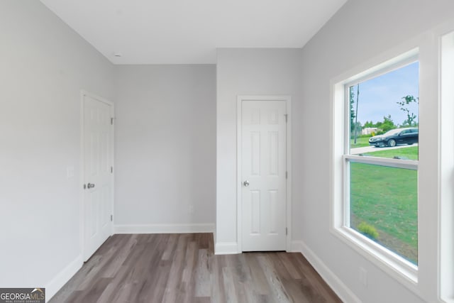unfurnished bedroom featuring wood finished floors and baseboards
