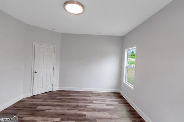 empty room featuring wood finished floors and baseboards