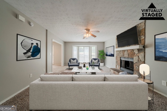 6351 Stablewood Way, Lithonia, GA 30058 - carpeted living area featuring a stone fireplace, a ceiling fan, and a textured ceiling
