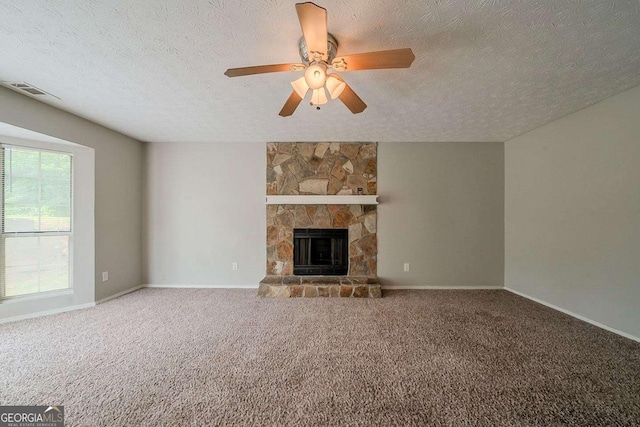 unfurnished living room with carpet flooring, a textured ceiling, and a fireplace