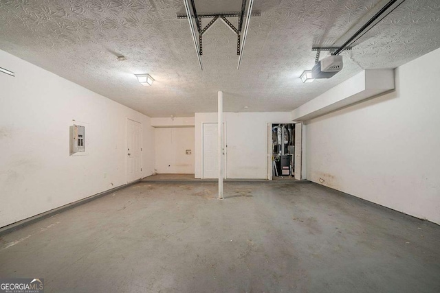 garage with electric panel and a garage door opener