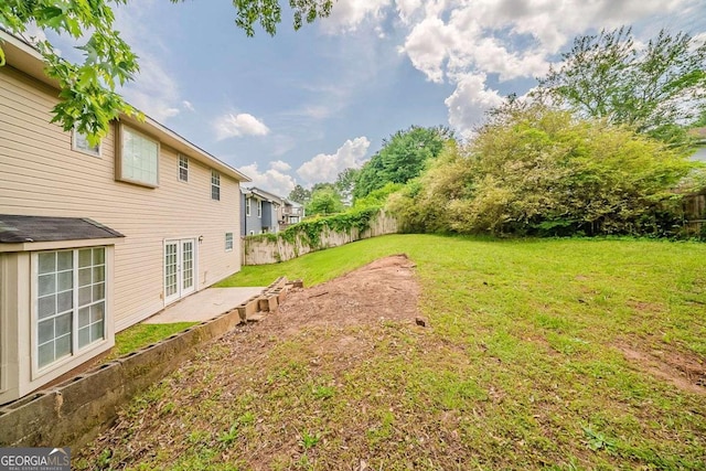 view of yard with a fenced backyard, a patio, and french doors