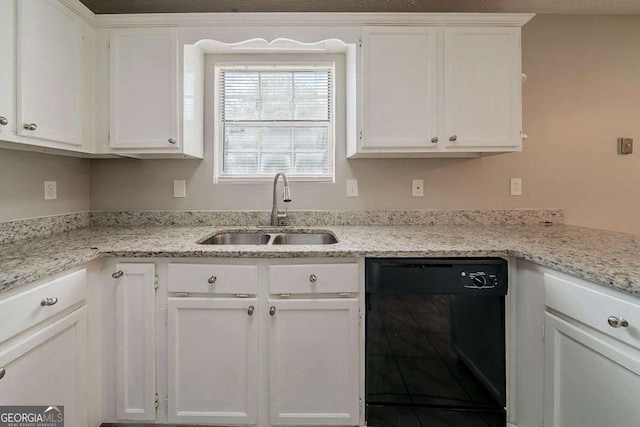 kitchen featuring dishwasher, white cabinetry, light stone countertops, and a sink