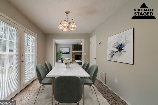 dining area featuring an inviting chandelier, light carpet, baseboards, and visible vents
