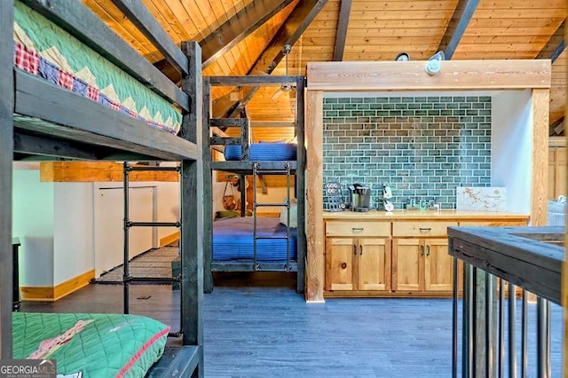 bedroom with lofted ceiling with beams, wooden ceiling, and wood finished floors