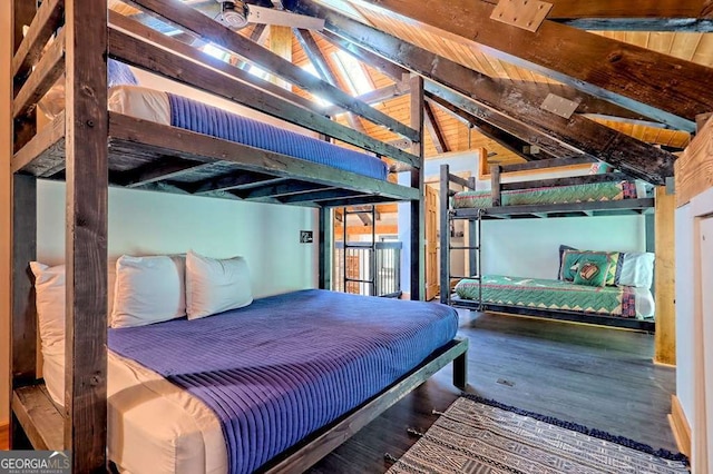 bedroom with lofted ceiling with beams, wood finished floors, and access to exterior