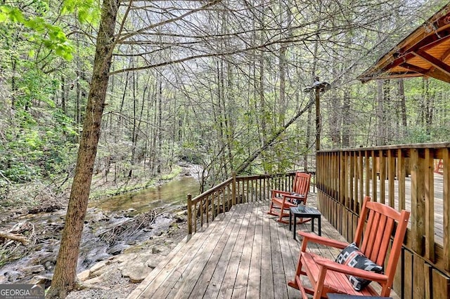 wooden deck with a view of trees