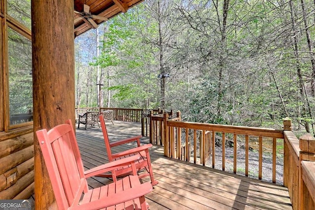 wooden terrace featuring ceiling fan