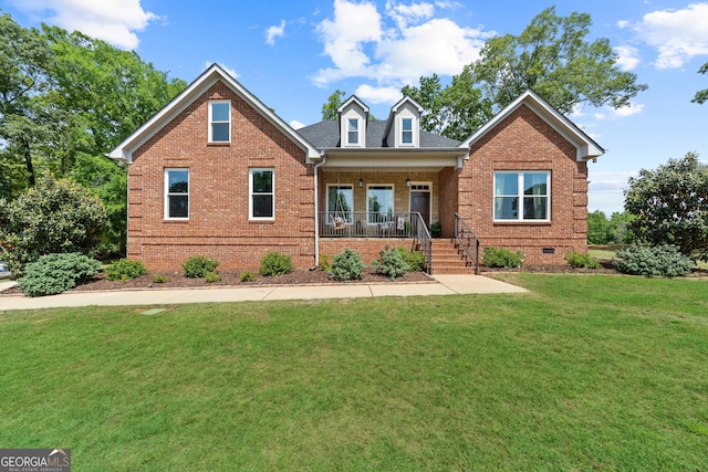 view of front of house with brick siding, a porch, crawl space, and a front yard