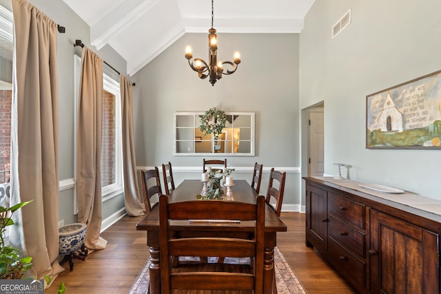 dining room featuring a chandelier, dark wood-style flooring, high vaulted ceiling, beamed ceiling, and baseboards