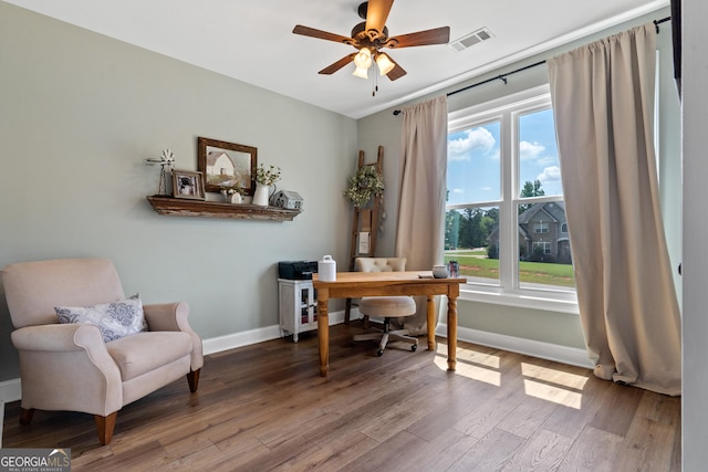 office space with wood finished floors, plenty of natural light, baseboards, and ceiling fan