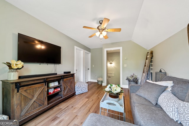 living room with ceiling fan, light wood-style flooring, and baseboards