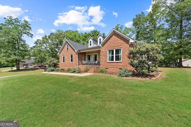 view of front of house featuring brick siding, a front yard, crawl space, and covered porch