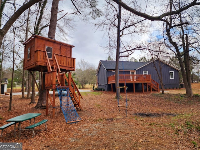view of jungle gym with stairway and a deck