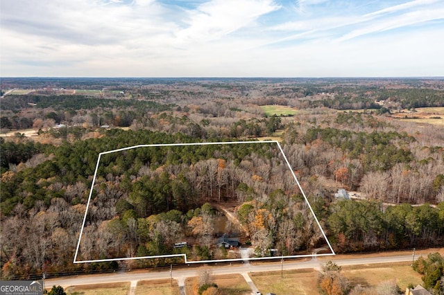 birds eye view of property with a forest view