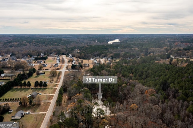 aerial view featuring a wooded view
