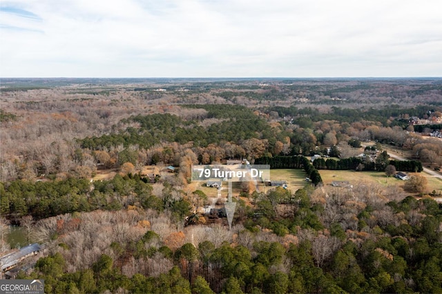 birds eye view of property featuring a wooded view