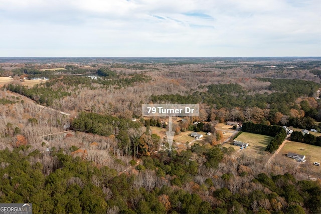 drone / aerial view with a wooded view