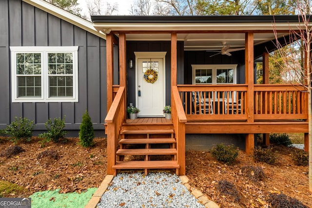 entrance to property with a porch, a ceiling fan, and board and batten siding