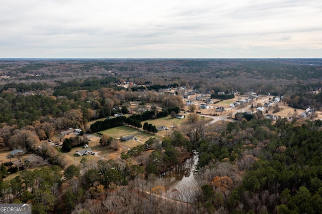 birds eye view of property featuring a forest view