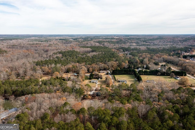 birds eye view of property with a wooded view