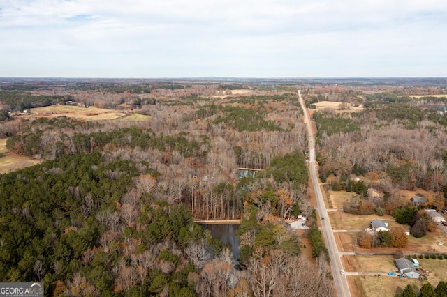 drone / aerial view featuring a view of trees
