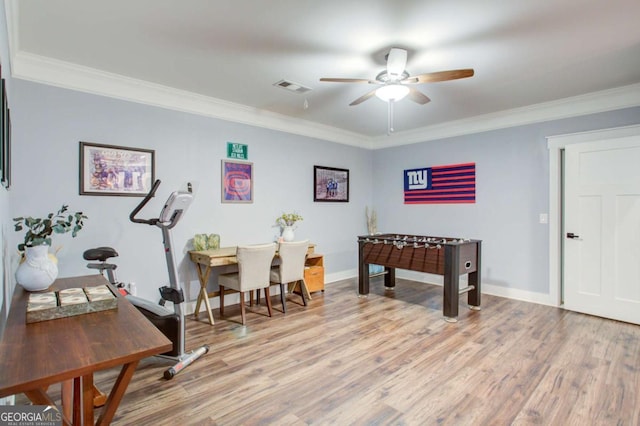 game room with visible vents, ornamental molding, light wood finished floors, and ceiling fan