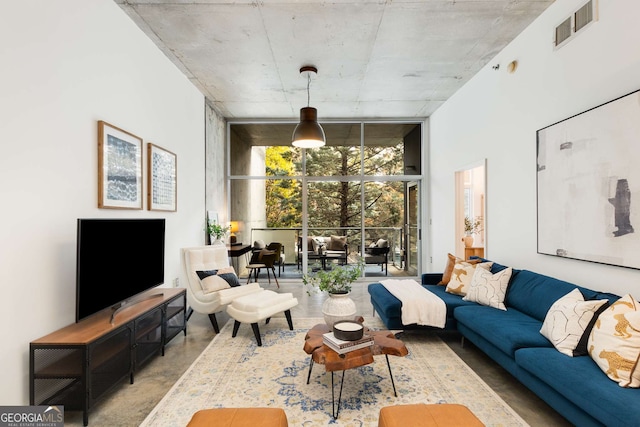 130 Arizona Ave NE Unit 104, Atlanta, GA 30307 - living area featuring expansive windows, finished concrete flooring, and a high ceiling