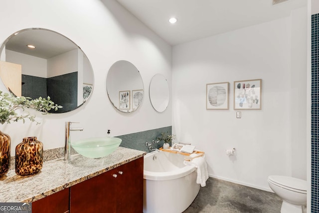 130 Arizona Ave NE Unit 104, Atlanta, GA 30307 - bathroom with a soaking tub, vanity, toilet, baseboards, and recessed lighting