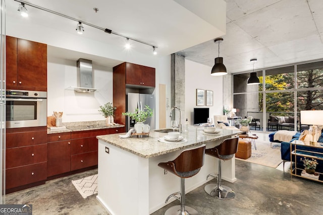130 Arizona Ave NE Unit 104, Atlanta, GA 30307 - kitchen featuring stainless steel appliances, wall chimney range hood, concrete flooring, and a sink