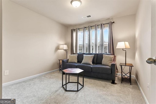 living area with carpet floors, baseboards, and visible vents