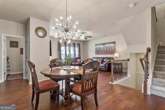 dining room featuring baseboards, ceiling fan with notable chandelier, stairs, and wood finished floors