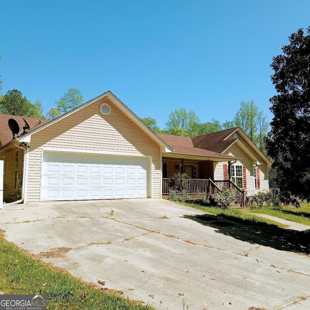 ranch-style house featuring an attached garage, driveway, and a porch