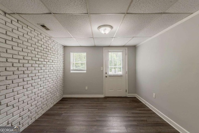 2465 Hogan Rd, Atlanta, GA 30344 - entryway with brick wall, a paneled ceiling, and dark wood-style floors