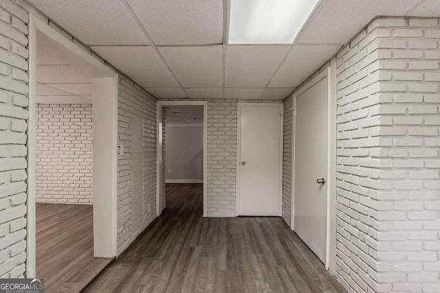 2465 Hogan Rd, Atlanta, GA 30344 - corridor with brick wall, a paneled ceiling, and wood finished floors