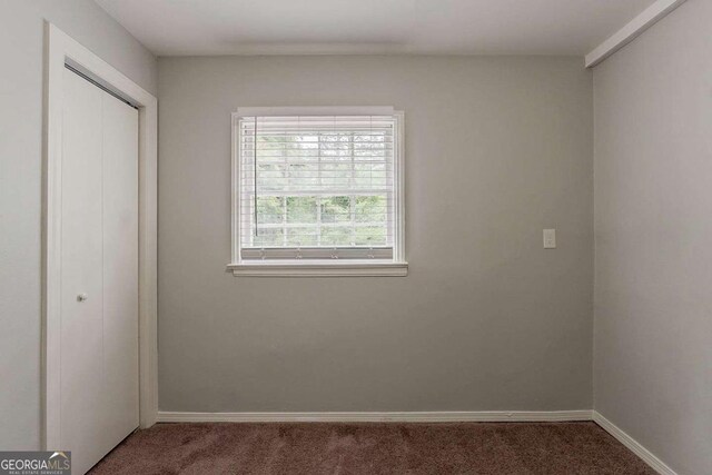 2465 Hogan Rd, Atlanta, GA 30344 - unfurnished bedroom featuring carpet floors and a closet