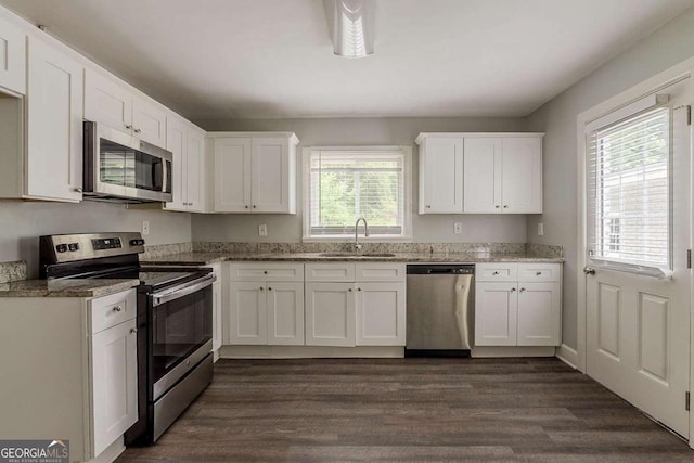 2465 Hogan Rd, Atlanta, GA 30344 - kitchen with stainless steel appliances, white cabinets, and light stone counters