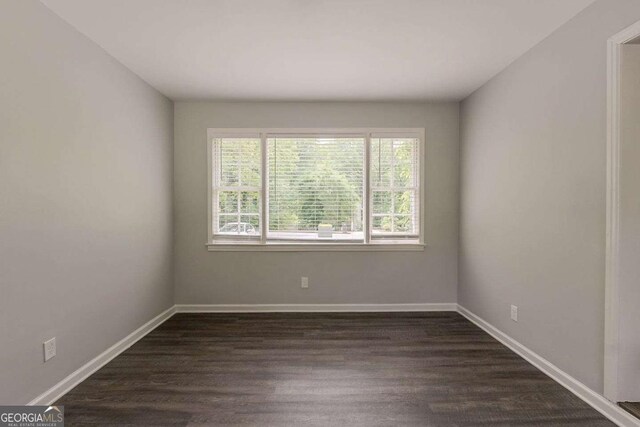 2465 Hogan Rd, Atlanta, GA 30344 - empty room with dark wood-style floors and baseboards