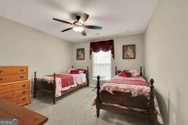 bedroom featuring baseboards, carpet flooring, and a ceiling fan