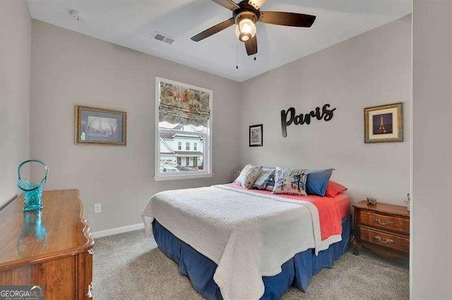 carpeted bedroom featuring baseboards, visible vents, and ceiling fan