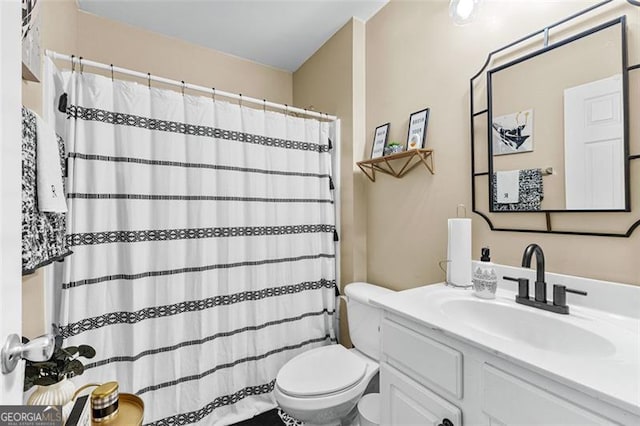 full bathroom with vanity, toilet, and curtained shower