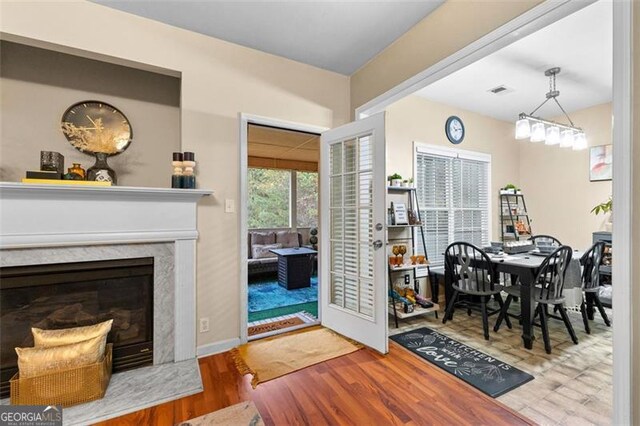 dining area with wood finished floors and a high end fireplace