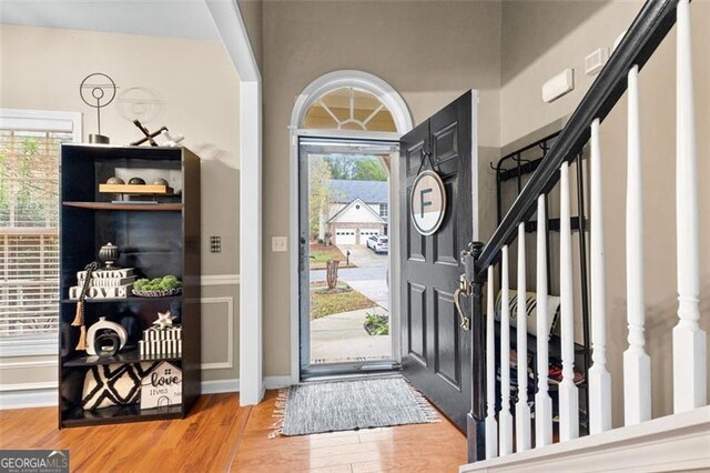 foyer with wood finished floors and stairway