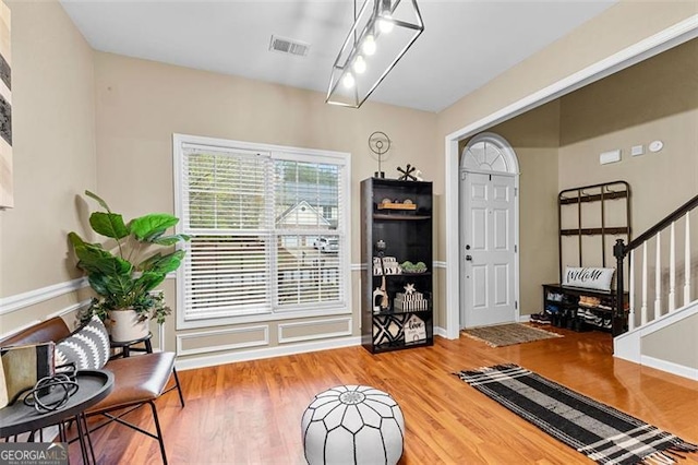 interior space with visible vents, wood finished floors, and stairway