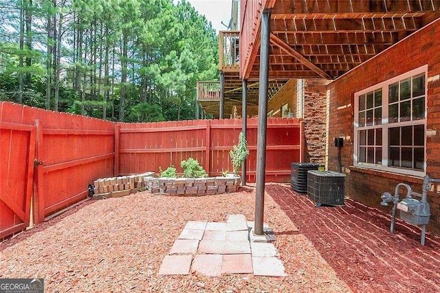 view of patio featuring a deck, central AC, and a fenced backyard