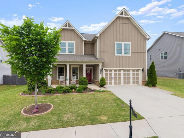 craftsman-style house featuring board and batten siding, a porch, a front yard, concrete driveway, and an attached garage