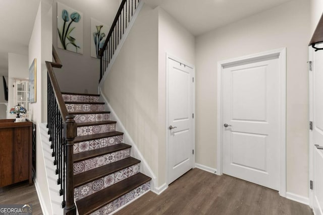 stairs featuring baseboards and wood finished floors
