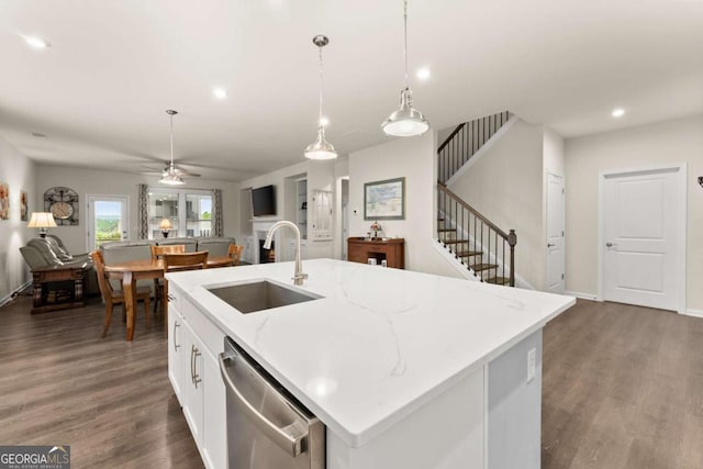 kitchen with wood finished floors, open floor plan, a sink, and dishwasher