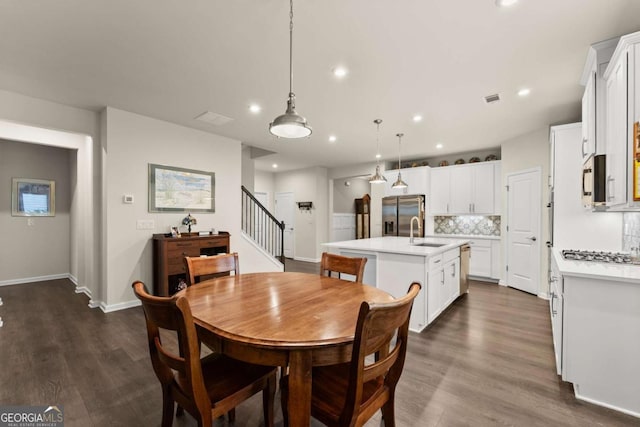 dining area featuring visible vents, stairs, baseboards, recessed lighting, and dark wood finished floors